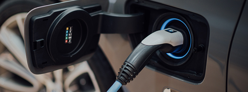 Electric car plugged in and being charged off peak
